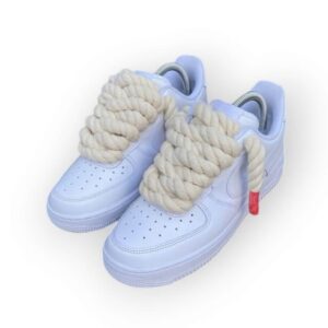 A fresh pair of Nike Air Force 1 sneakers with chunky white laces, styled for a clean and modern streetwear look.