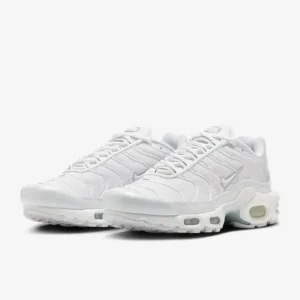 Nike Air Max Plus ‘Triple White’ women’s sneaker on a clean backdrop, featuring all-white mesh upper, glossy TPU overlays, visible Tuned Air units, and whale tail-inspired midfoot shank