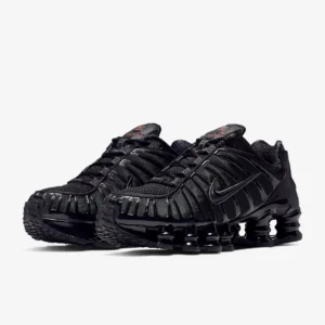 Nike Shox TL ‘Black’ sneaker on a clean backdrop, featuring black mesh upper, glossy TPU cage, full-length Shox columns, and sculpted midfoot shank